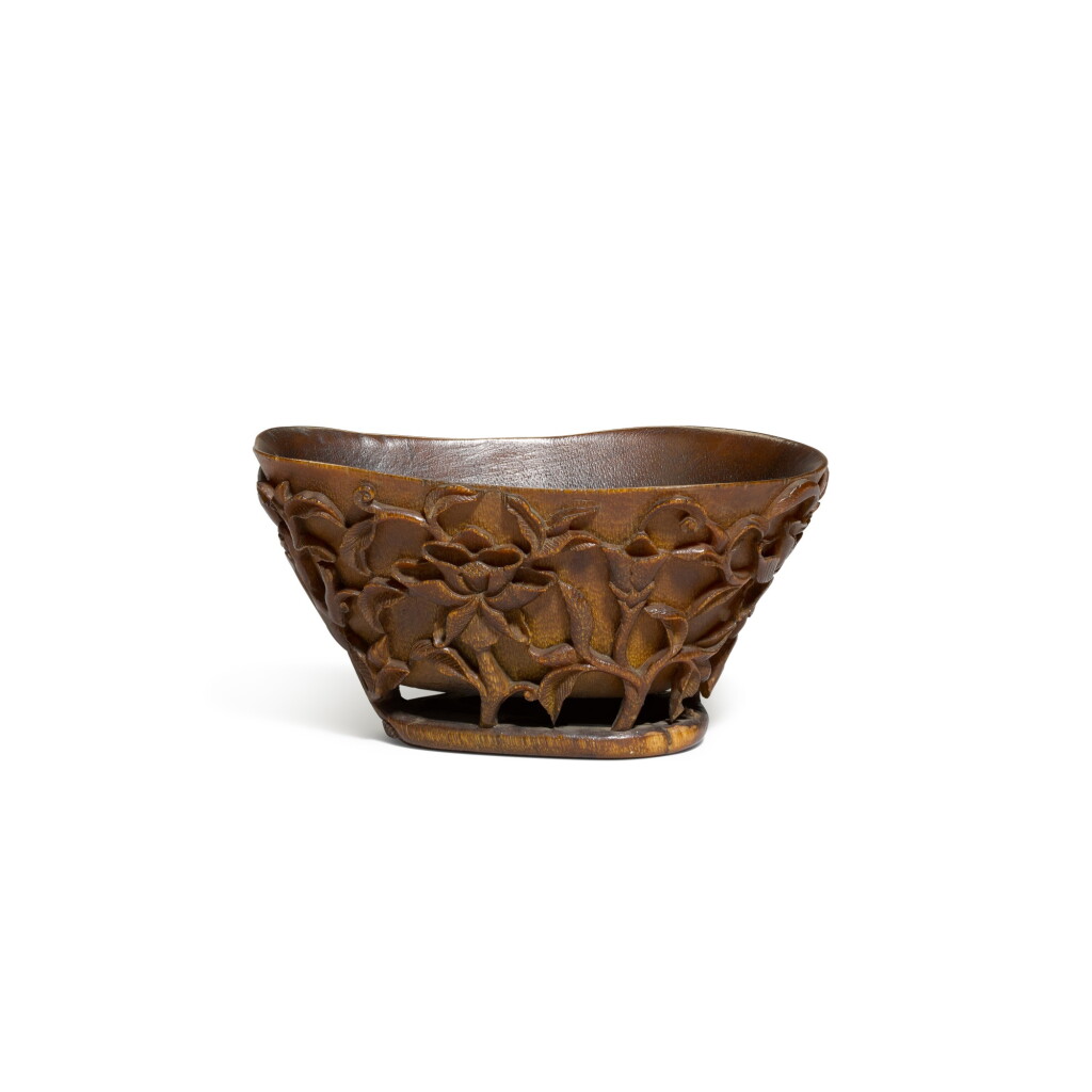 View full screen - View 1 of Lot 34. A horn libation cup, Qing dynasty, 18th century | 清十八世紀 角雕穿花螭龍紋盃.