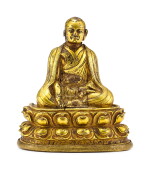 A GILT-BRONZE FIGURE OF A LAMA, TIBET, 13TH – 14TH CENTURY | 十三至十四世紀 藏傳鎏金銅喇嘛坐像