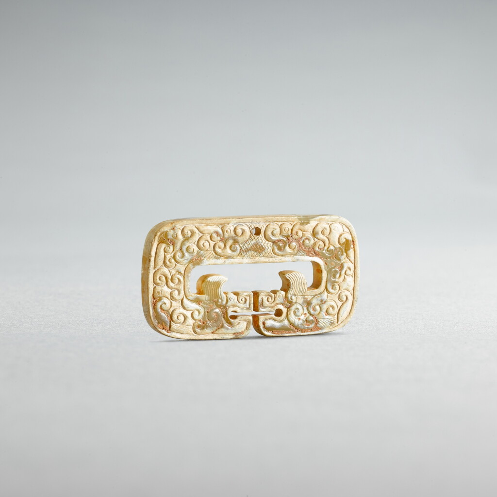 View full screen - View 1 of Lot 738. A celadon jade 'dragon' pendant, Eastern Zhou dynasty, Spring and Autumn period or later | 東周春秋或更晚 青玉卷雲紋雙龍珮.