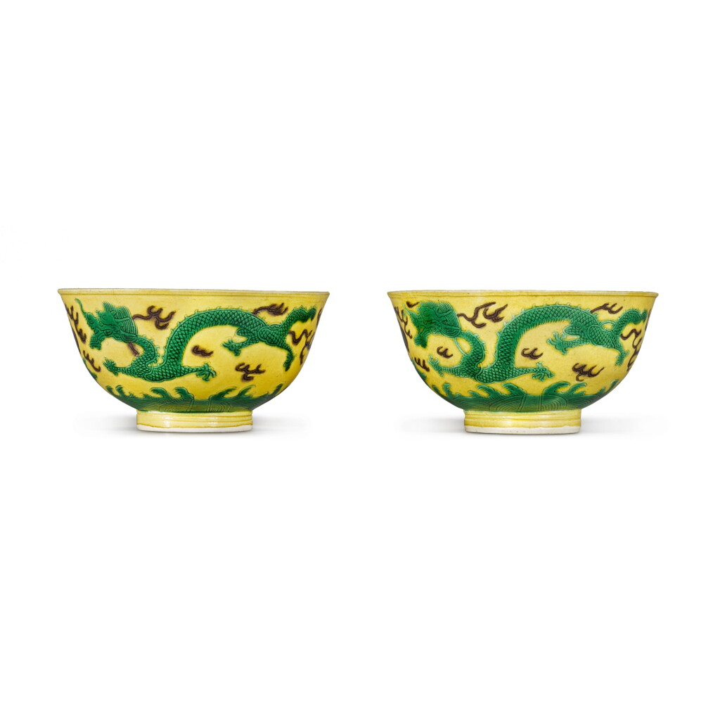 View full screen - View 1 of Lot 98. A pair of yellow ground, aubergine and green enamelled 'dragon' bowls Marks and period of Kangxi | 清康熙 黃地紫綠彩雲龍盌一對 《大清康熙年製》款.