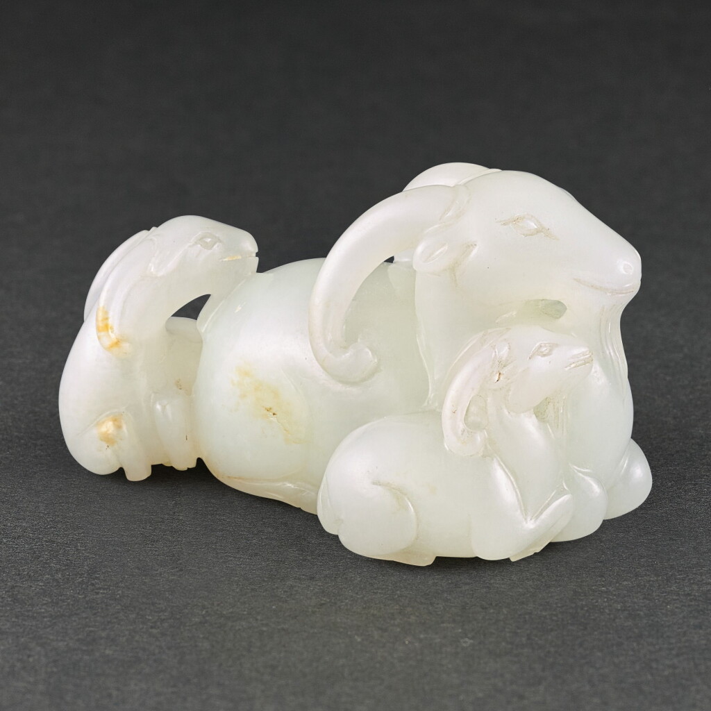 View full screen - View 1 of Lot 574. A WHITE JADE 'SANYANG' GROUP QING DYNASTY | 清 白玉三羊開泰把件.