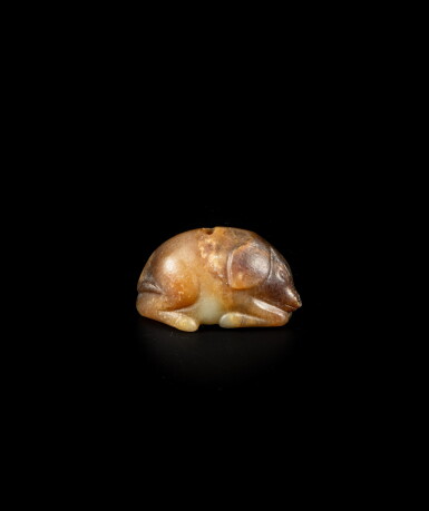 View full screen - View 1 of Lot 217. A small russet and yellow jade figure of a pig, Tang dynasty or earlier | 唐或更早 黃玉豬.