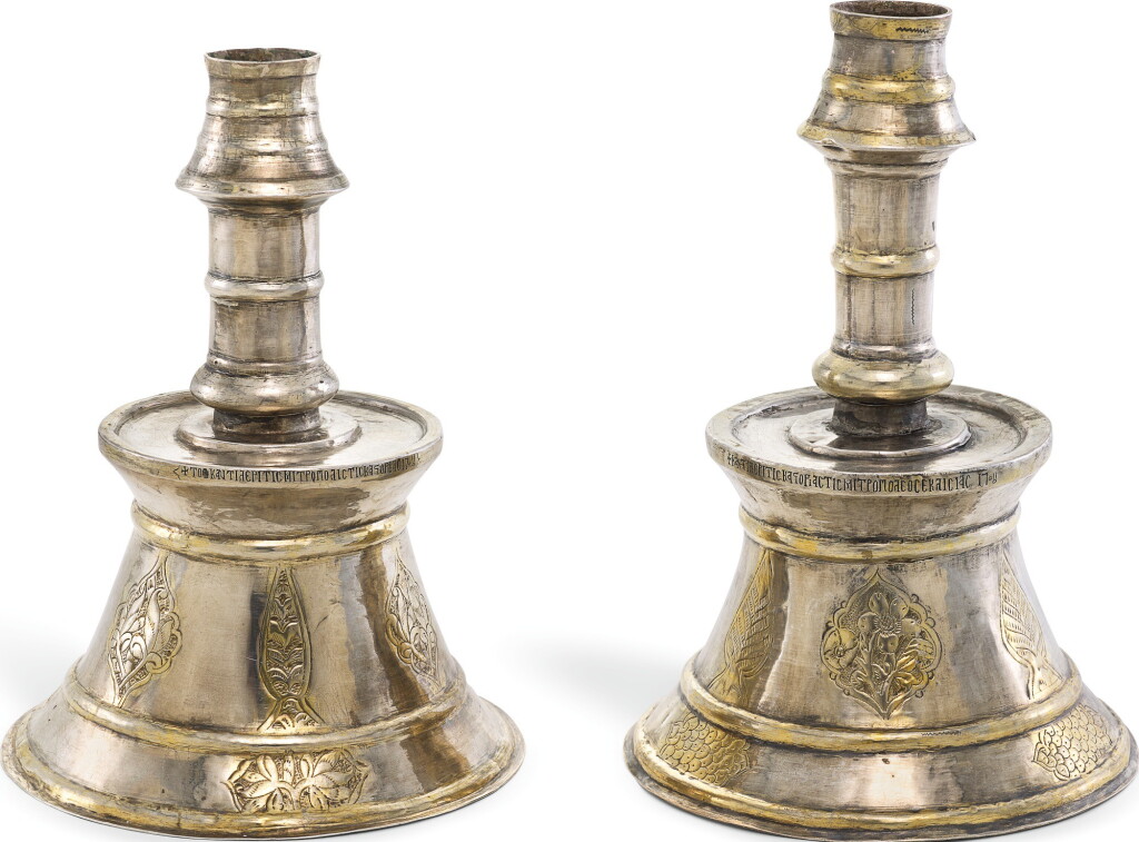 View full screen - View 1 of Lot 282. A RARE PAIR OF OTTOMAN SILVER-GILT CANDLESTICKS WITH GREEK INSCRIPTIONS, TURKEY, DATED 1708.