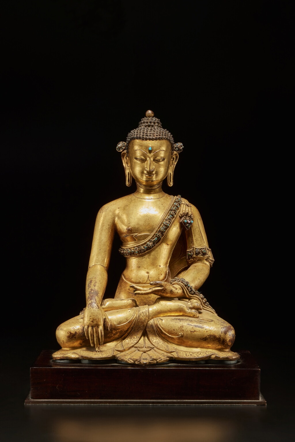 View full screen - View 1 of Lot 561. A hardstone filigree gilt-copper alloy figure of Shakyamuni Buddha, Nepal, 15th / 16th century.