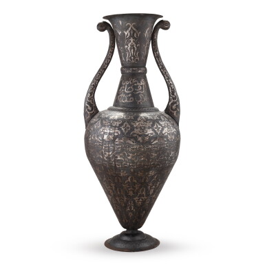 View full screen - View 1 of Lot 53. A very large two-handled silver damascened metal trophy vase, probably Morocco, circa 1880 | Très grand vase-trophée à deux anses en métal damasquiné d'argent, probablement Maroc, vers 1880.