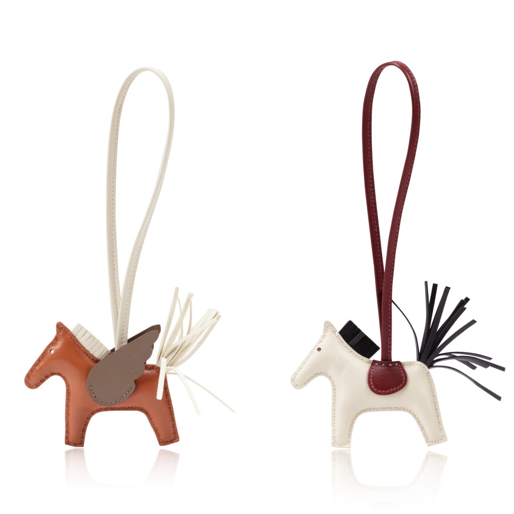 View full screen - View 1 of Lot 581. Set of 2 Charms : 1 Nata, Black and Rouge H Swift Rodeo Charm, 2023 and 1 Marron, Etoupe and Nata Swift Pégase Charm, 2023.