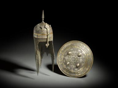 View full screen - View 1 of Lot 155. A fine Qajar silver and gold-overlaid steel helmet and matching shield Persia, second half 19th century.