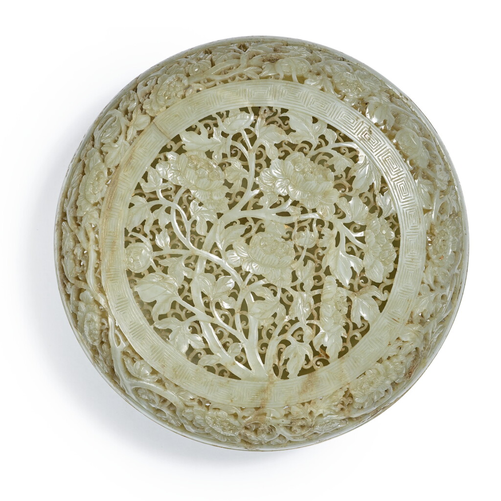 View full screen - View 1 of Lot 4. A celadon jade reticulated 'peony' box and cover, Qing dynasty, 18th century | 清十八世紀 青玉透雕纏枝牡丹紋蓋盒 .