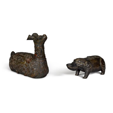View full screen - View 1 of Lot 41. A bronze water dropper in the form of a mythical beast and an inscribed and silver-inlaid bronze figure of a crouching mythical beast Ming dynasty or earlier | 明或更早 銅瑞獸形水注 及 銅錯銀瑞獸 一組兩件.