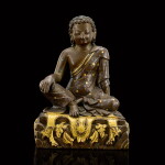 A gold and silver-inlaid parcel-gilt copper alloy figure of Milarepa Tibet, 18th-19th century | 十八至十九世紀 西藏局部鎏金銅錯金銀密勒日巴坐像