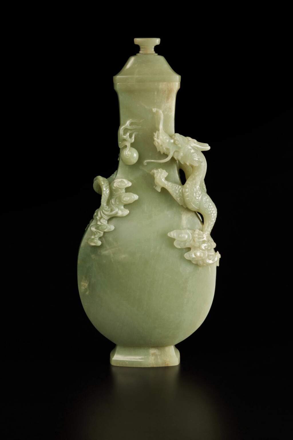 View full screen - View 1 of Lot 211. A large celadon jade 'dragon' vase and cover, Qing dynasty, 18th / early 19th century | 清十八 / 十九世紀初 青玉浮雕趕珠雲龍紋蓋瓶.