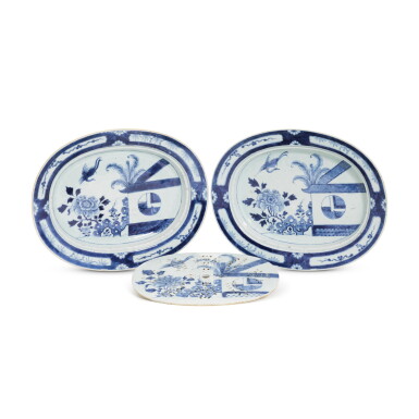 View full screen - View 1 of Lot 8. A pair of Chinese export porcelain blue and white 'Cuckoo in the House' pattern oval serving dishes and a pierced strainer, Qing dynasty, circa 1800.