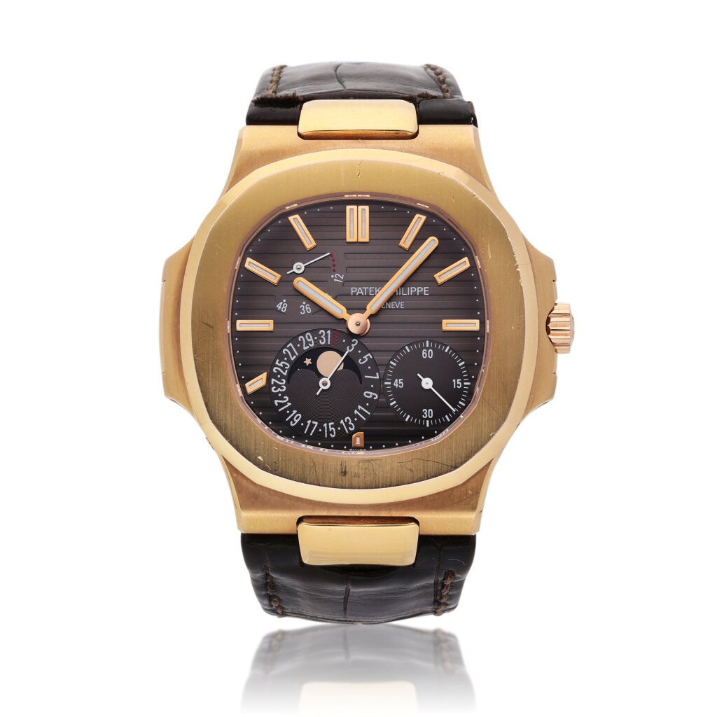 View full screen - View 1 of Lot 83. Reference 5712 Nautilus | A pink gold automatic wristwatch with date, power reserve, and moon phases, Circa 2010.