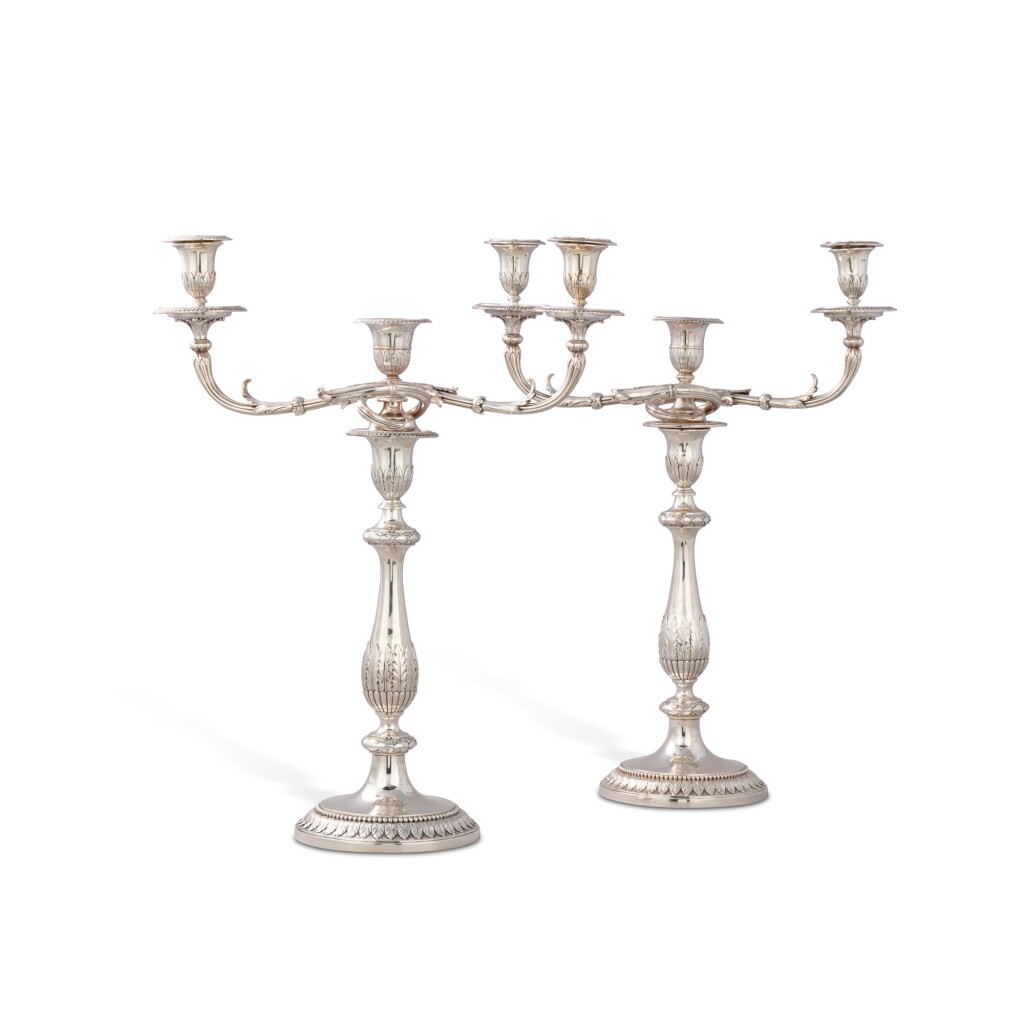 View full screen - View 1 of Lot 126. A matching pair of large George III silver three-light candelabra, one by John Scofield, London, 1791, the other by Richard Cook, London, 1807.