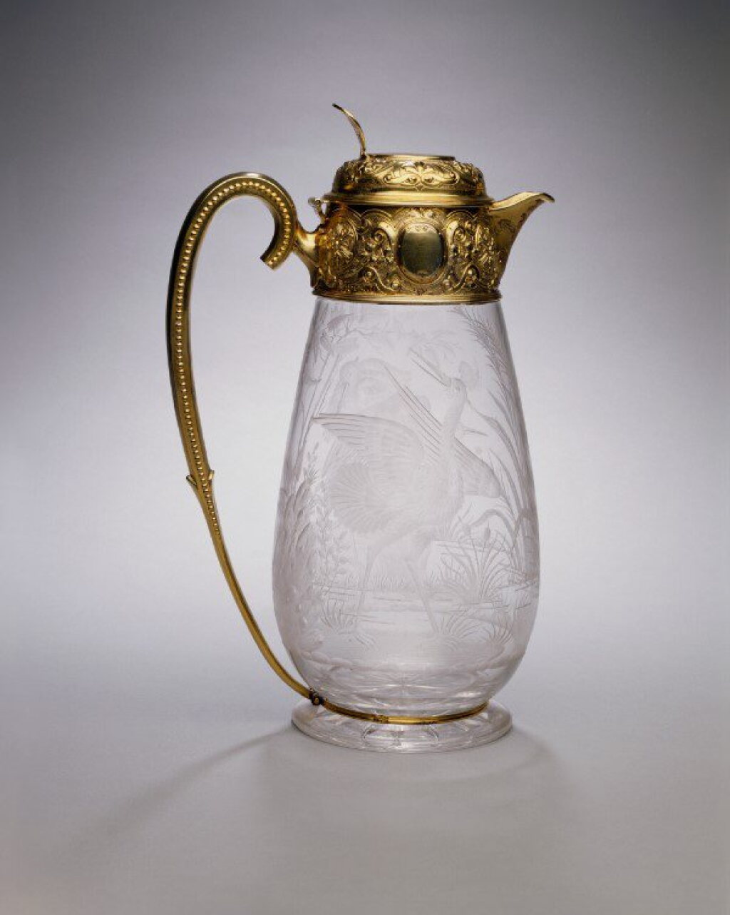 View full screen - View 1 of Lot 315. A Victorian Silver-Gilt Mounted Engraved Glass Claret Jug, William and George Sissons, Sheffield, 1877.