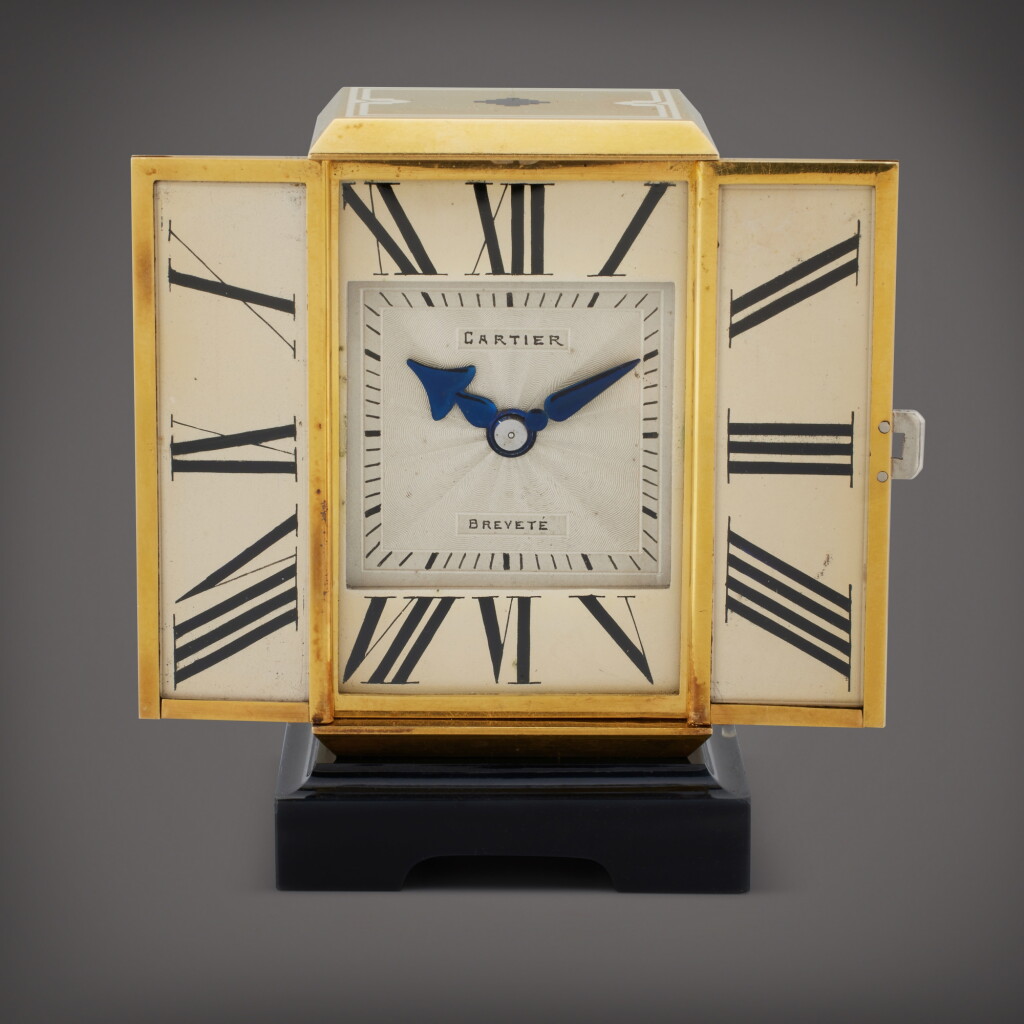 View full screen - View 1 of Lot 50. A yellow gold, enamel, onyx, and diamond-set miniature triptych desk timepiece, Circa 1930.