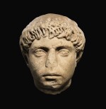A ROMAN MARBLE PORTRAIT HEAD OF A YOUNG MAN, HADRIANIC, CIRCA A.D. 130-140