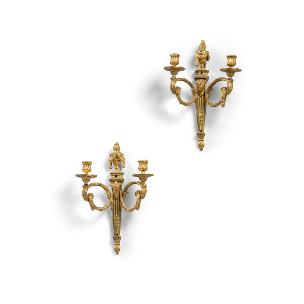 View full screen - View 1 of Lot 426. A pair of Louis XVI style gilt-bronze two-light wall-lights, 19th century, in the taste of Quentin-Claude Pitoin.