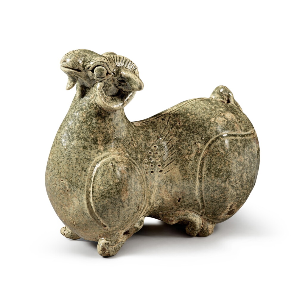 View full screen - View 1 of Lot 200. A celadon-glazed 'Yue' figure of a ram, Western Jin dynasty | 西晉 越窰青釉臥羊.