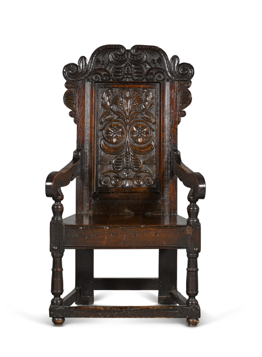 View full screen - View 1 of Lot 24. A Charles II carved oak panel-back armchair.