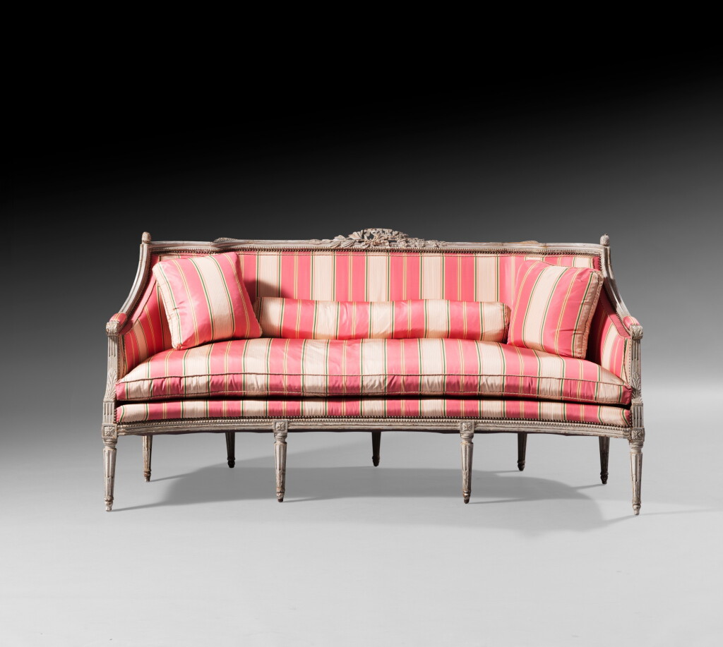 View full screen - View 1 of Lot 56. A carved and cream lacquered canapé, Louis XVI, circa 1780 | Canapé d'alcôve en bois laqué crème d'époque Louis XVI, vers 1780.