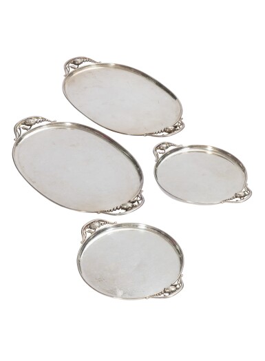 View full screen - View 1 of Lot 117. A pair of oval hammered silver trays and a pair of circular hammered silver trays, "Blossom" pattern, Jensen, Copenhagen, modern | Paire de plateaux ovales et paire de plateaux ronds en argent martelé, modèle Blossom, par Jensen, Copenhague, moderne.