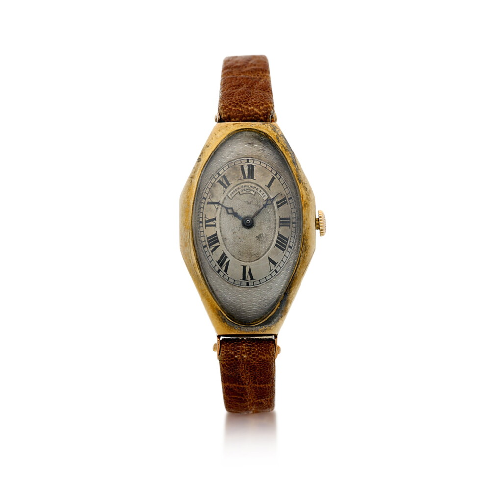 View full screen - View 1 of Lot 138. A YELLOW GOLD TONNEAU OVAL WRISTWATCH, MADE IN 1917.
