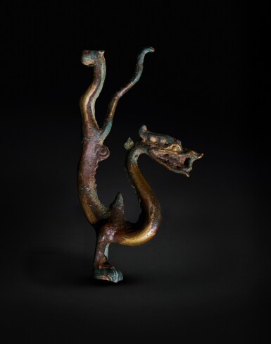 View full screen - View 1 of Lot 168. A rare gilt-bronze figure of a dragon, Tang dynasty .