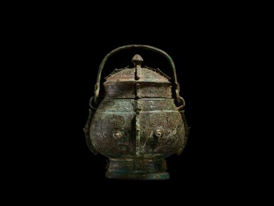 View full screen - View 1 of Lot 3610. An extremely rare and important archaic bronze ritual wine vessel and cover, you, Shang dynasty, Yinxu period | 商代殷墟時期 青銅饕餮紋卣.