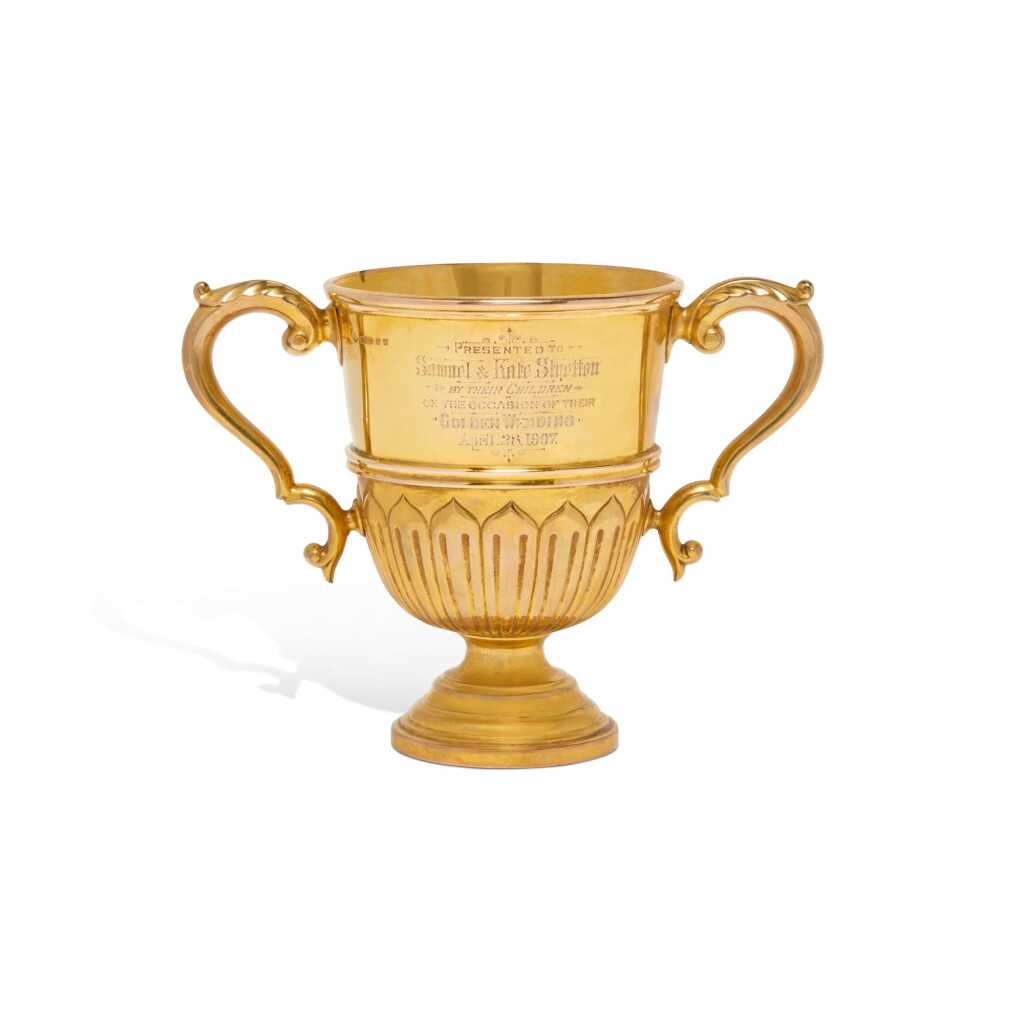 View full screen - View 1 of Lot 557. An Edwardian 9 Karat Gold Two-Handled Cup, Horace Woodward & Co. Ltd., Birmingham, 1906.