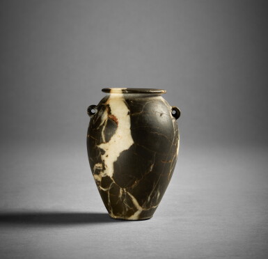 View full screen - View 1 of Lot 358. An Egyptian Breccia Lug Handle Jar, Predynastic Period, circa 3500-3000 B.C..