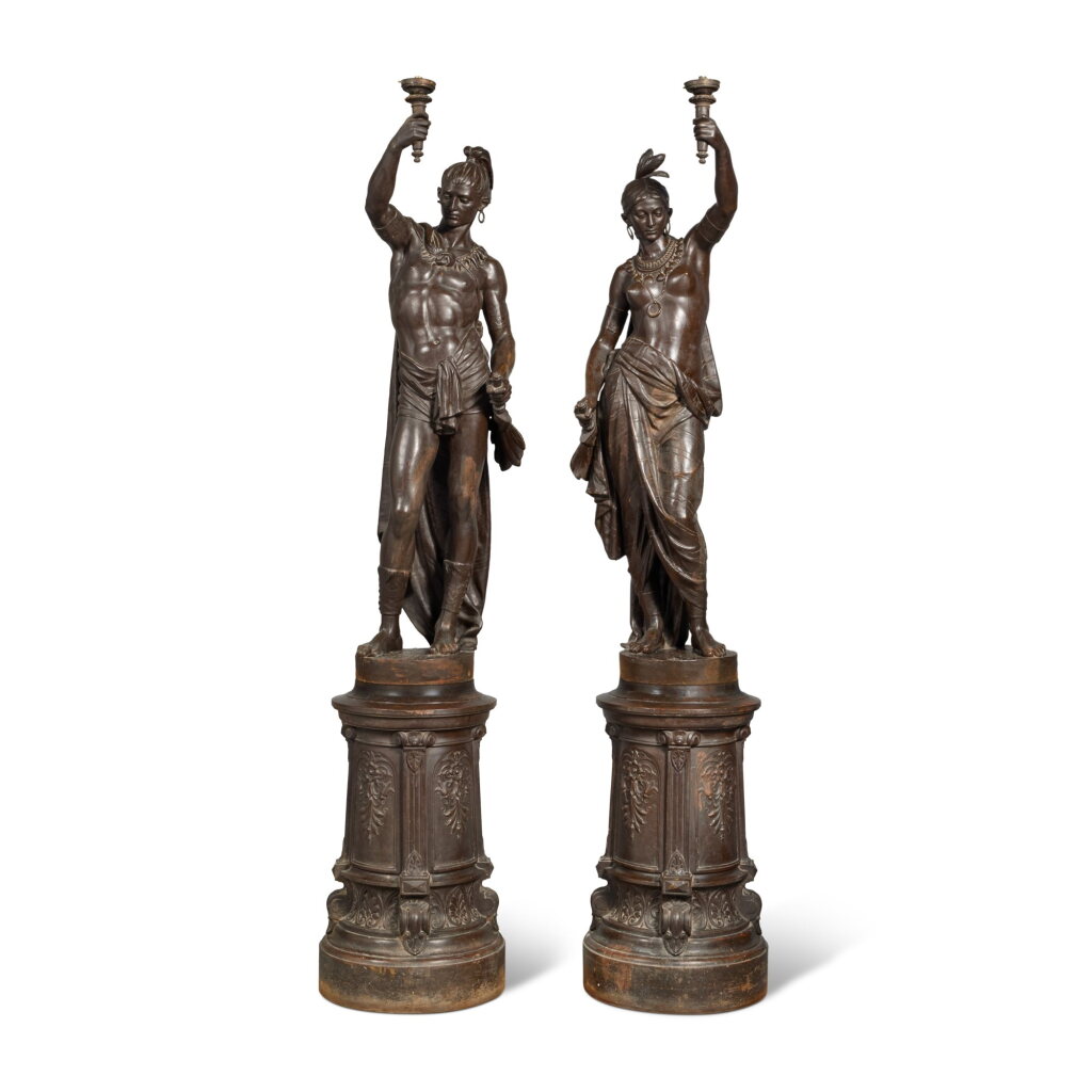 View full screen - View 1 of Lot 681. A Pair of French Life-Sized Cast-Iron Sculptures-Torchères of Native American Indians Titled "L’ Indienne" After A Design by Jean-Jules Salmson (French, 1823-1902) Attributed to Le Fonderies d'Art du Val d'Osne, 19th Century.