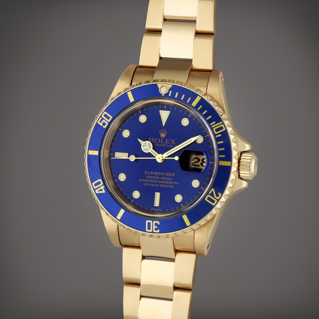 View full screen - View 1 of Lot 149. Reference 16618 Submariner | A yellow gold automatic wristwatch with date and bracelet, Circa 1999.