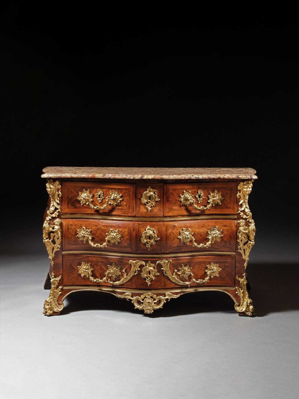 View full screen - View 1 of Lot 130. An early Louis XV gilt-bronze and brass mounted kingwood veneered commode, circa 1720-1730, stamped later by Jean-Charles Saunier.