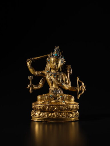View full screen - View 1 of Lot 120. A silver-inlaid gilt copper alloy figure of Manjushri, Tibet, 15th century | 西藏 十五世紀 銅合金鎏金錯銀嵌寶文殊菩薩坐像.