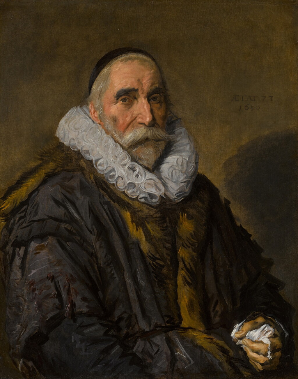 View full screen - View 1 of Lot 136. Portrait of a gentleman, half-length, in a brown fur-trimmed coat, with a large white ruff and black skull cap, holding a handkerchief.