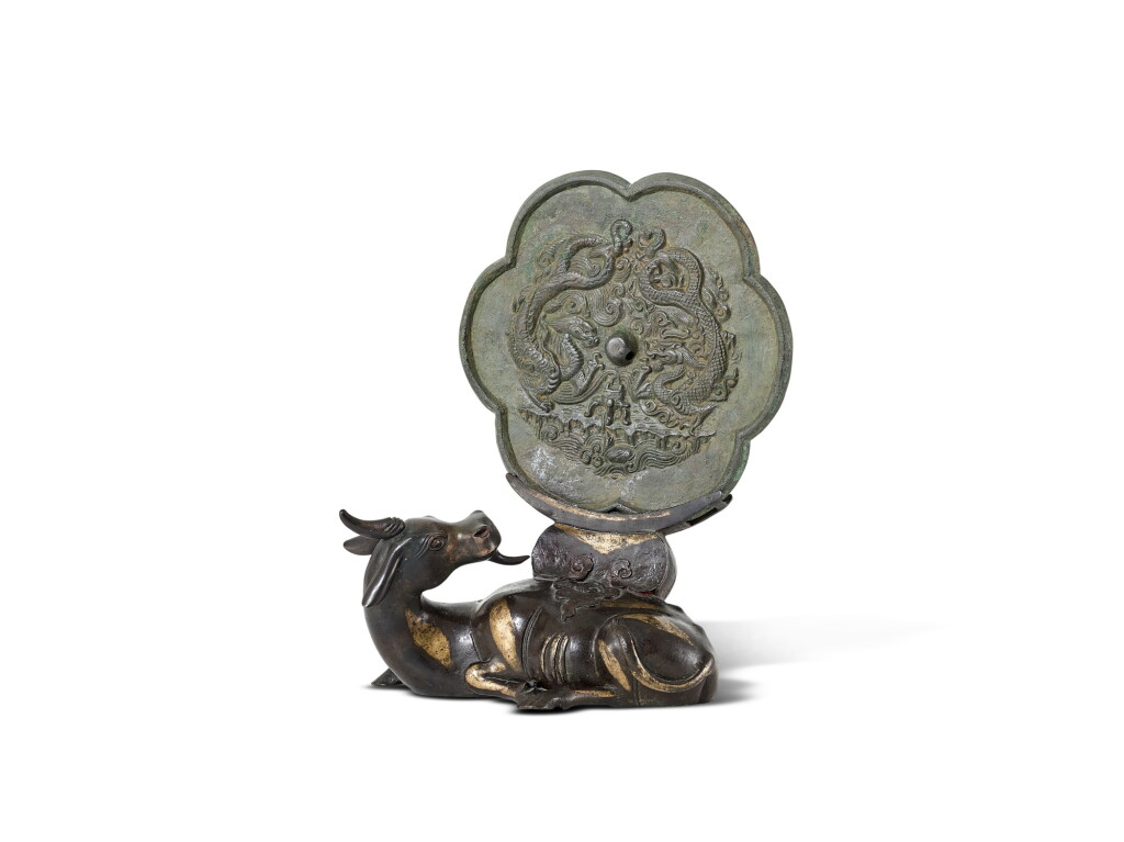 View full screen - View 1 of Lot 5049. A bronze 'twin dragon' mirror, Song dynasty, and a parcel-gilt bronze mirror stand, Ming dynasty 宋 銅雙龍紋花式鏡 及 明 局部鎏金銅犀牛望月鏡架.