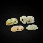 Two pale celadon jade recumbent dogs, Song dynasty, and two celadon jade dogs, 20th century 宋 青白玉臥犬兩件 及 二十世紀 青玉犬兩件