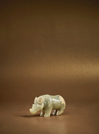 View full screen - View 1 of Lot 105. An extremely rare pale green jade carving of a rhinoceros, Early Western Zhou dynasty .