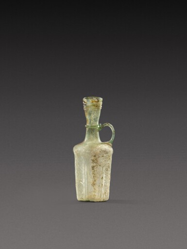 View full screen - View 1 of Lot 206. A Roman Pale Green Mould-Blown Glass Jug, circa 1st Century A.D..