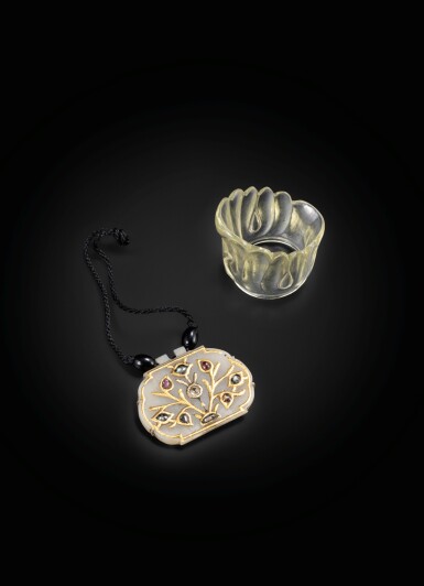 View full screen - View 1 of Lot 249. A small Mughal style embellished celadon jade pendant and a rock crystal archer ring Probably India, 19th century | 或為印度 十九世紀 痕都斯坦式玉珮及水晶扳指一組兩件.