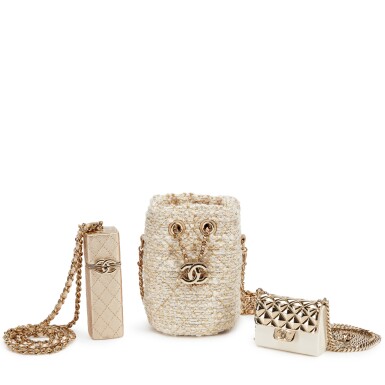 View full screen - View 1 of Lot 1101. Set of Three White Resin and Gold Quilted Metal Micro Bag with Chain Pale Gold Hardware, Gold Quilted Lambskin Lipstick Case Pale Gold Hardware, 2020 and Gold and White Tweed Micro Bucket Bag Pale Gold Hardware, 2021.