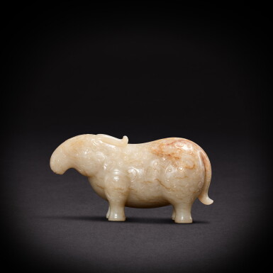 View full screen - View 1 of Lot 9480. A white and russet jade archaistic mythical animal, Qing dynasty, 18th century | 清十八世紀 白玉仿古瑞獸.