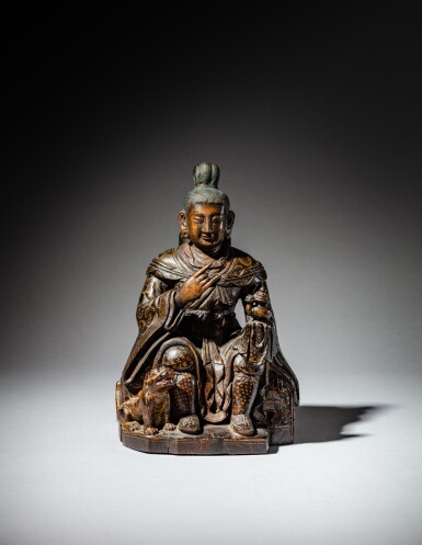 View full screen - View 1 of Lot 179. A polychrome wood figure of the luohan attendant Dharmatala, Tibet, 17th - 18th century | 十七至十八世紀 藏傳木雕彩繪達摩多羅尊者漢坐像.