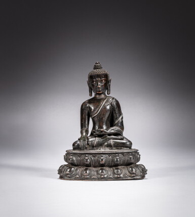 View full screen - View 1 of Lot 180. A silver-inlaid bronze figure of Shakyamuni Buddha, Yuan dynasty, circa 14th century | 元約十四世紀 銅錯銀釋迦牟尼佛坐像.