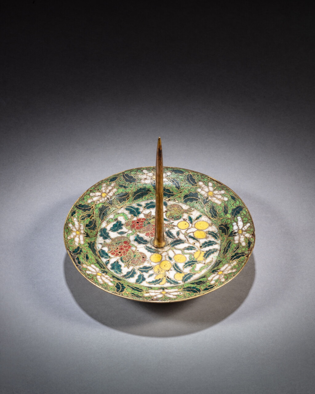 View full screen - View 1 of Lot 117. A cloisonné enamel ‘loquat and pomegranate’ candlestick, Ming dynasty, 16th / 17th century | 明十六 / 十七世紀 銅胎掐絲琺瑯枇杷石榴紋燭臺.