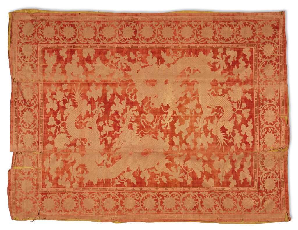 View full screen - View 1 of Lot 974. A coral-red-ground cut-velvet and metallic thread 'dragon' kang cover, Qing dynasty, 18th / 19th century | 清十八 / 十九世紀 紅地趕珠龍紋漳絨炕毯.