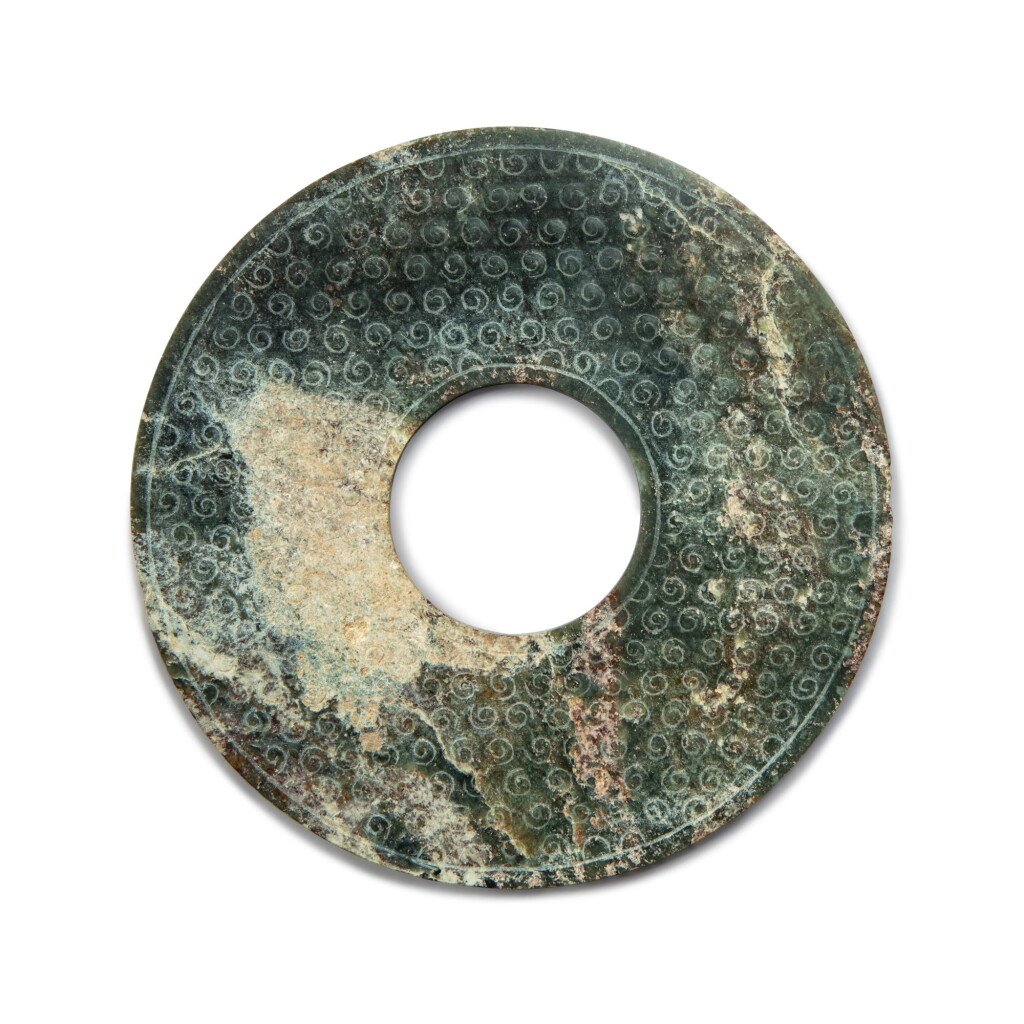 View full screen - View 1 of Lot 44. A dark green jade bi disc, Late Warring States period / Western Han dynasty | 戰國末 / 西漢 玉穀紋璧.