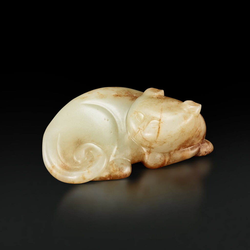 View full screen - View 1 of Lot 3671. A white and russet jade figure of a badger, Ming dynasty | 明 白玉臥獾.