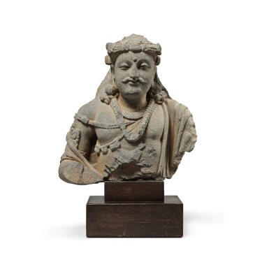 View full screen - View 1 of Lot 113. A gray schist bust of a bodhisattva, Ancient region of Gandhara, circa 2nd / 3rd century | 犍陀羅 約二 / 三世紀 灰片岩雕菩薩半身像 .